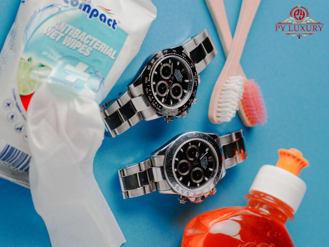 Tools for cleaning a Rolex replica watch, including a microfiber cloth, brush, and soap